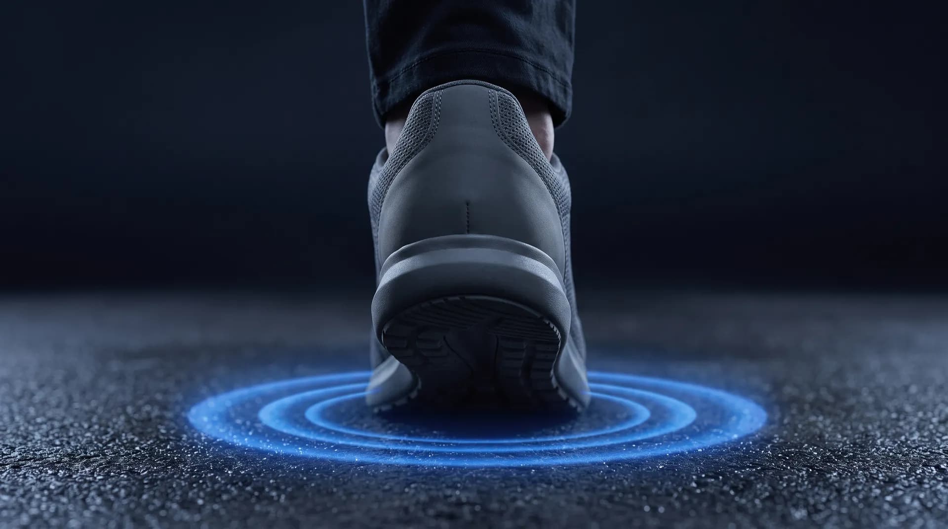 Researchers in a lab measure an insole with digital calipers as foot-pressure heat maps display on a monitor beside them